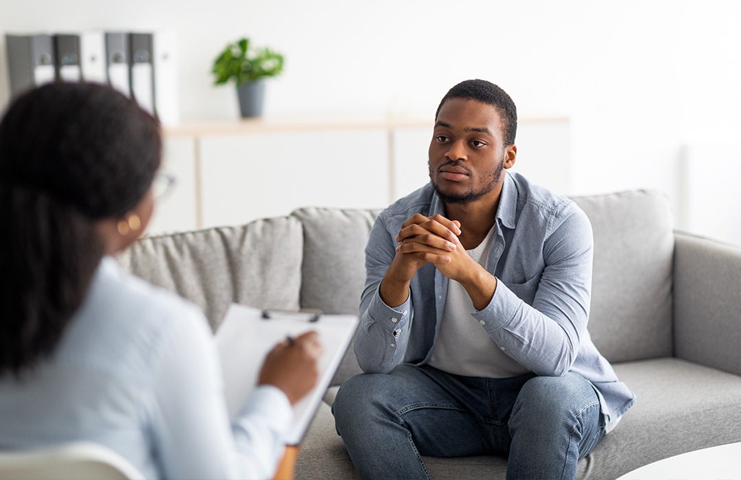 person sitting on couch talking to a therapist